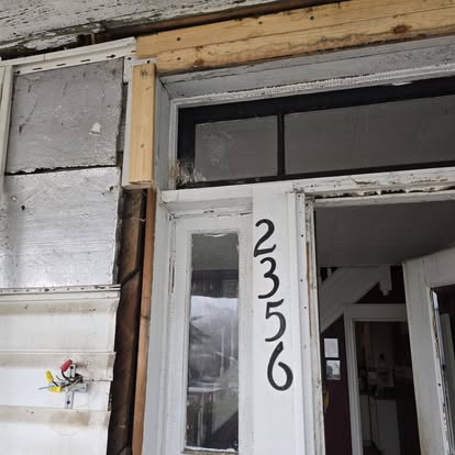 Close-up of a newly framed exterior doorway during a siding and entry replacement project